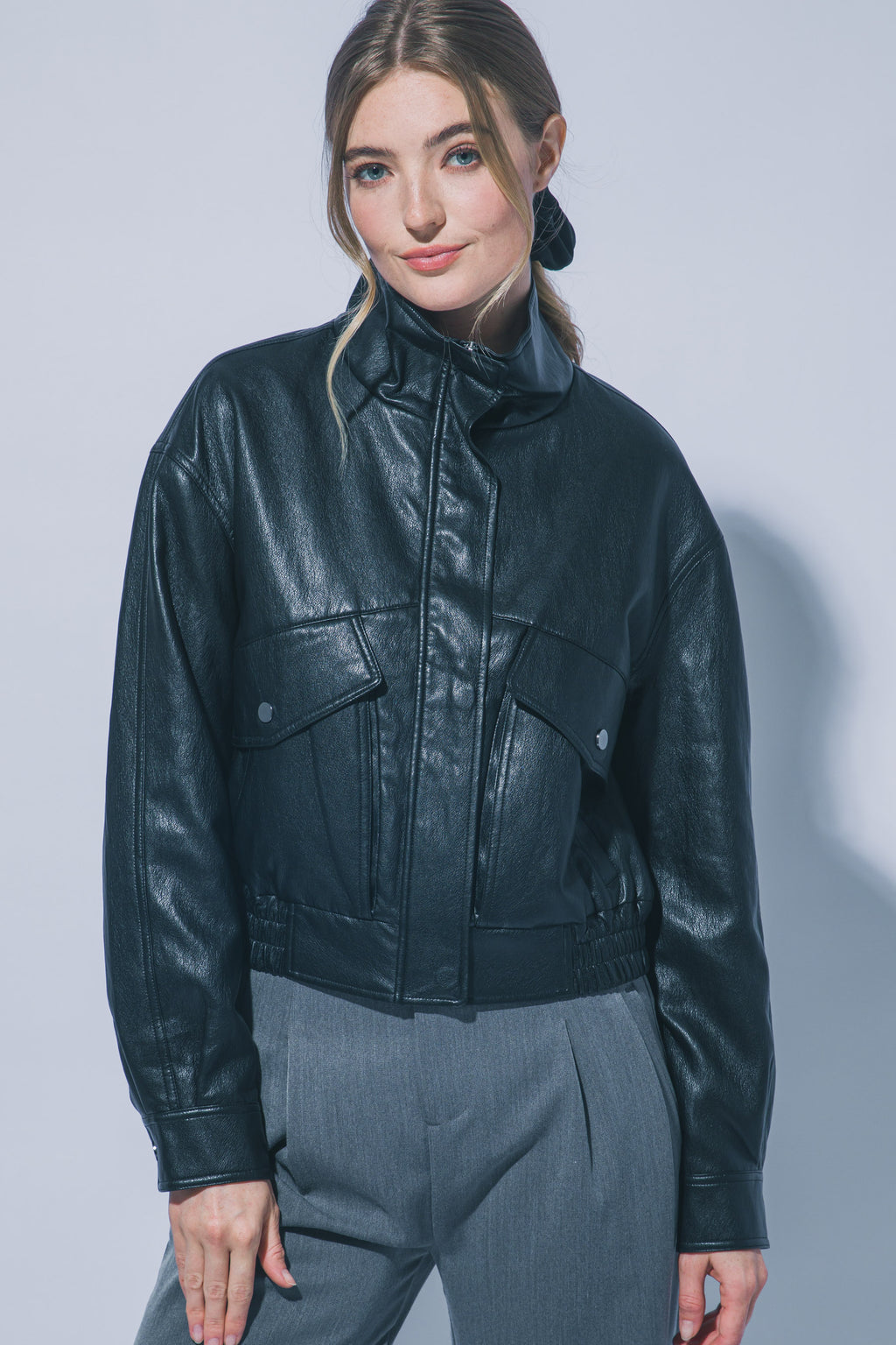 Women's black faux leather bomber jacket with flap pockets – front view