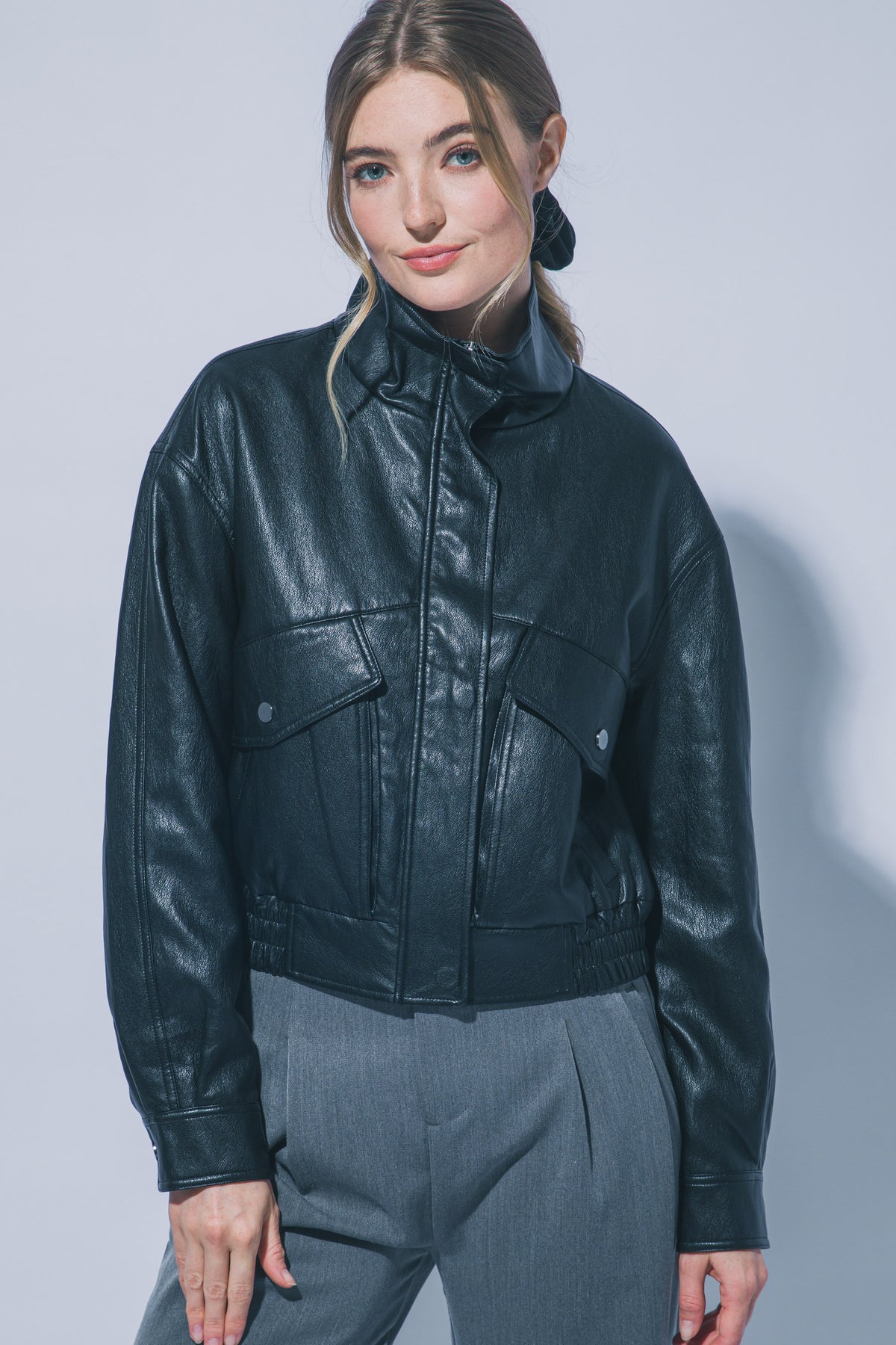 Women's black faux leather bomber jacket with flap pockets – front view