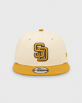 New Era San Diego Padres cream and tan 9FIFTY snapback hat front view with SD logo