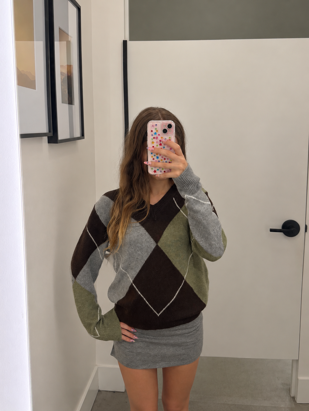 Model wearing women's brown argyle knit sweater