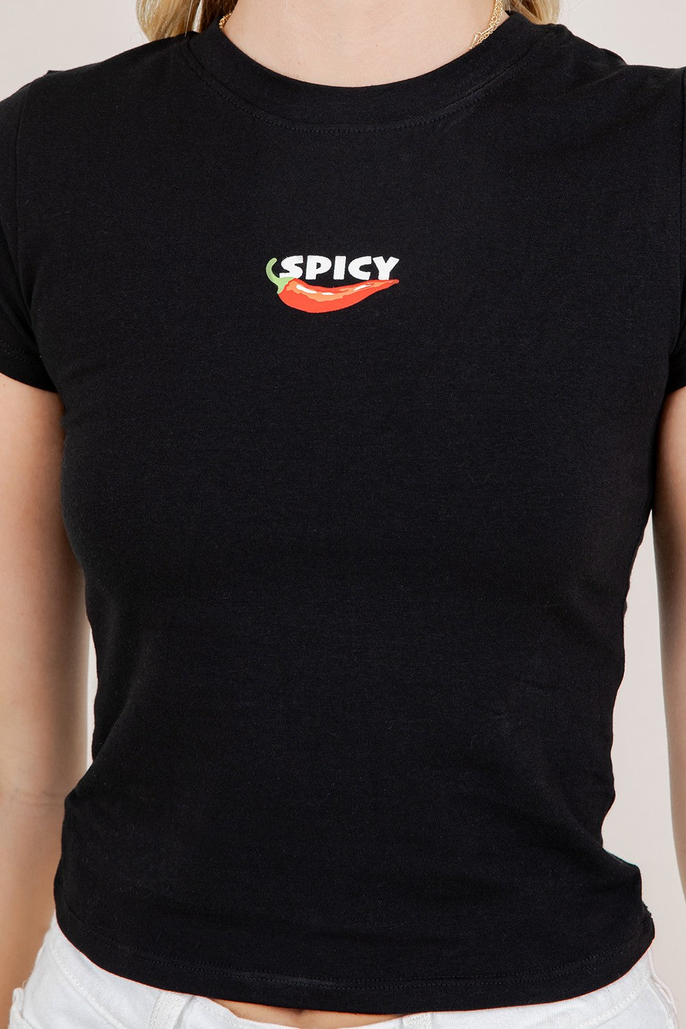 Black baby tee with bold Spicy graphic